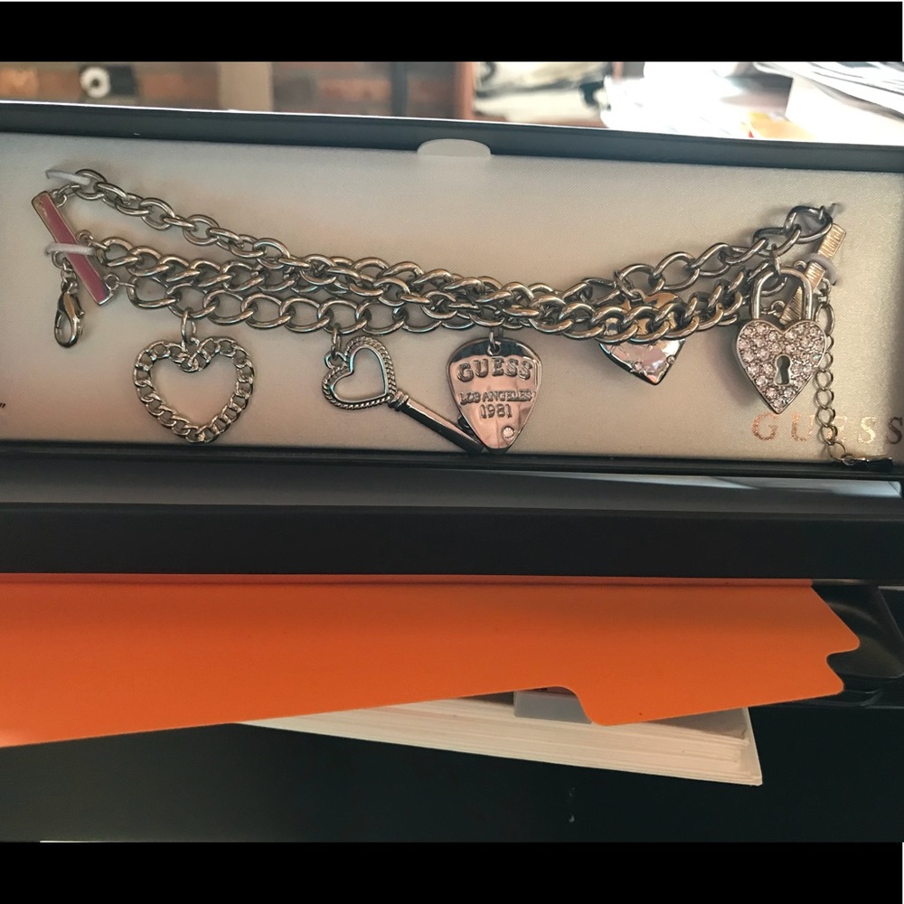 Guess - silver tone charm bracelet.
